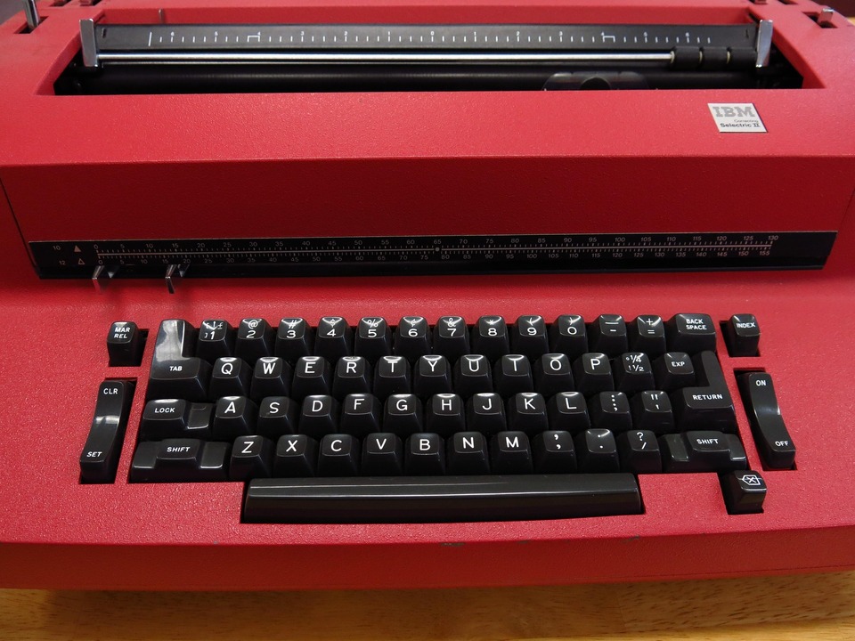 Red IBM Selectric II electric typewriter with black QWERTY keys